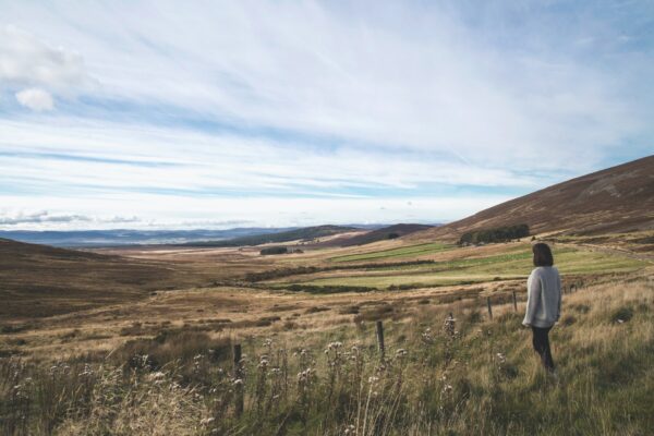 Woman standing in large field