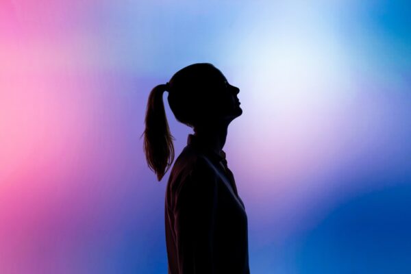 Silhouette of a woman with a ponytail.